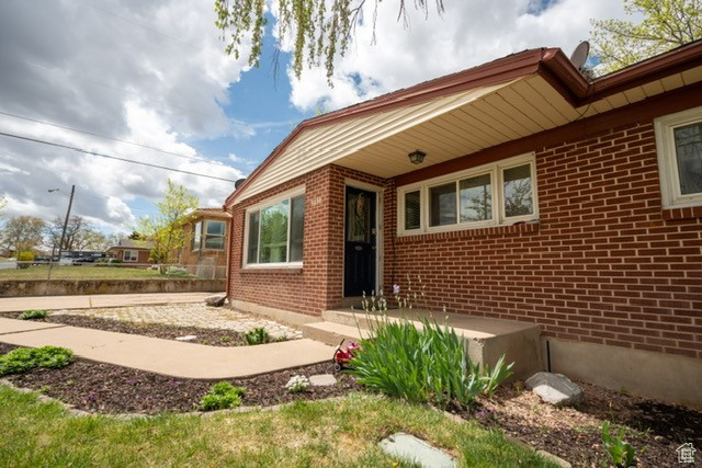 Entrance to property featuring brick siding