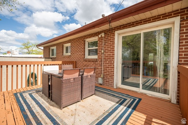 Wooden deck featuring outdoor dining space