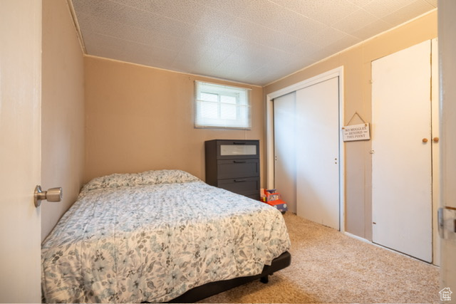 Bedroom with carpet and a closet