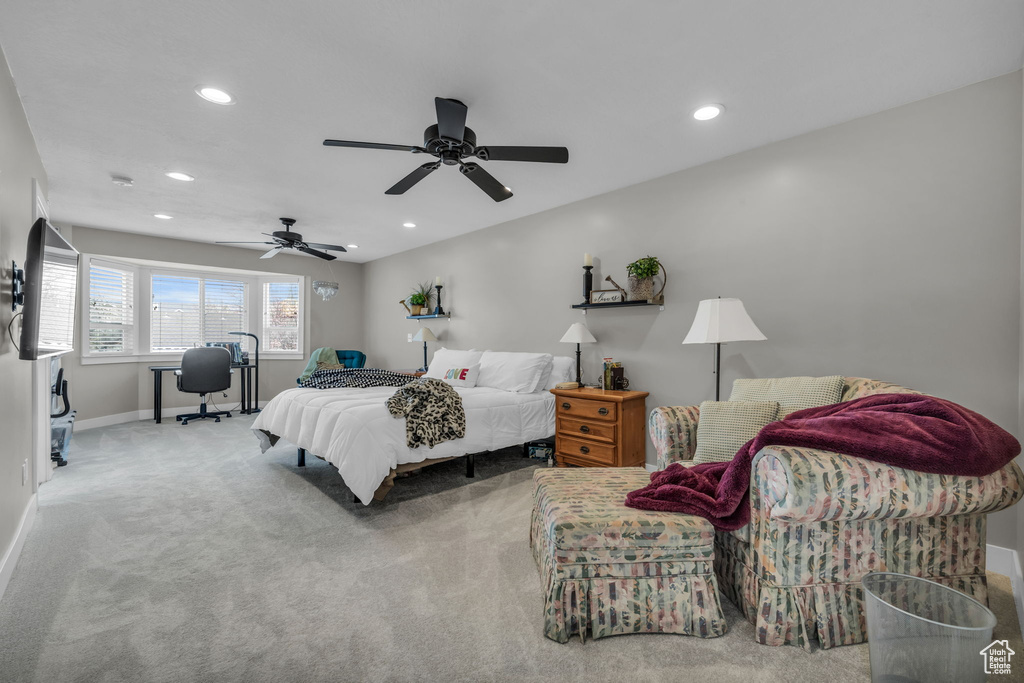 Carpeted bedroom featuring baseboards, a ceiling fan, and recessed lighting