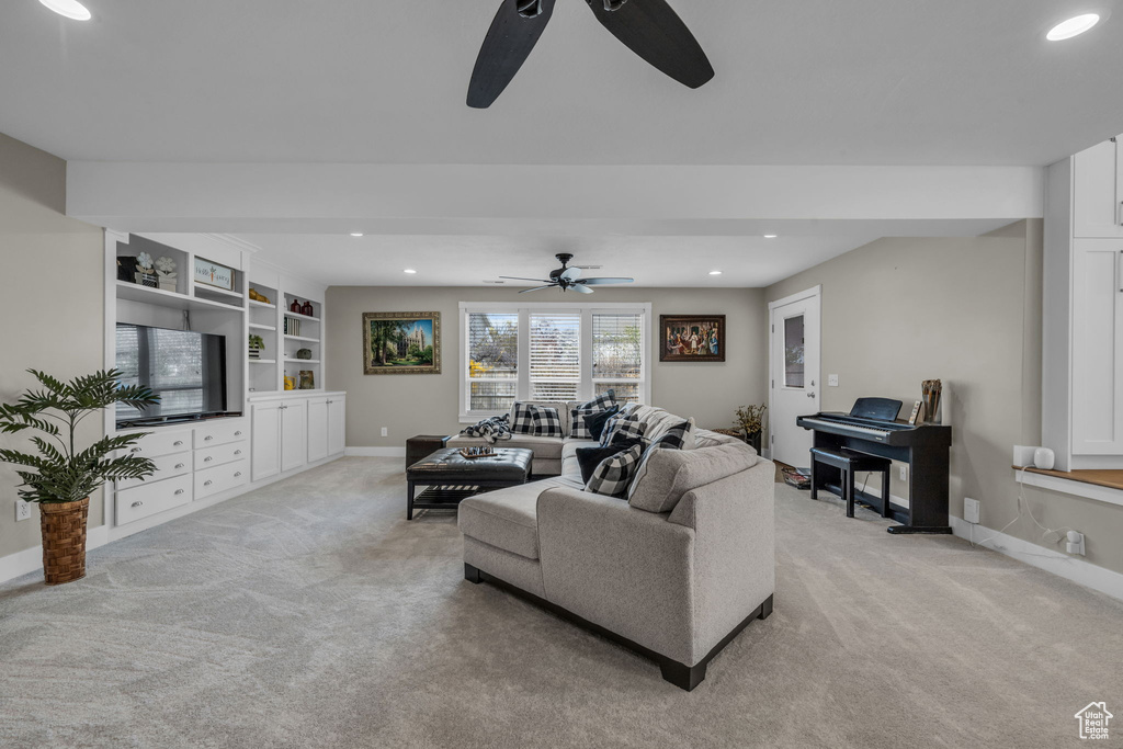 Living room with light carpet, a ceiling fan, and recessed lighting