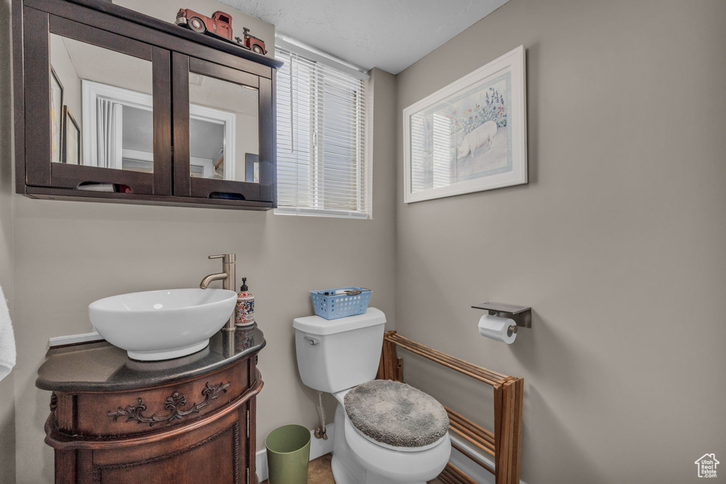 Half bath featuring vanity and toilet