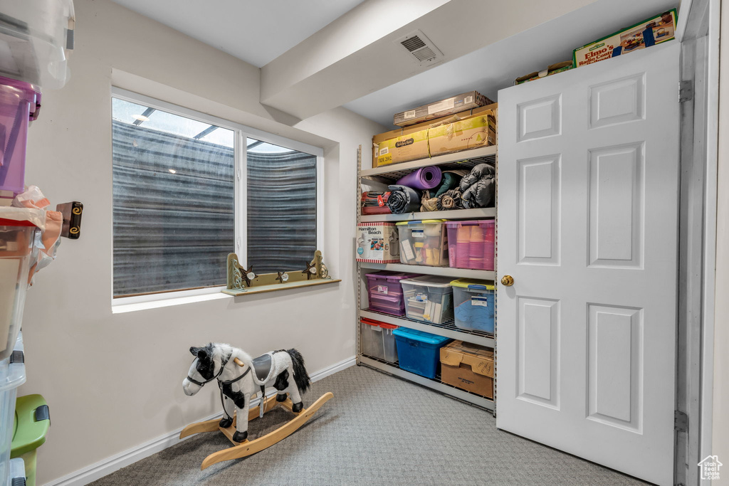 Rec room featuring carpet flooring, visible vents, and baseboards