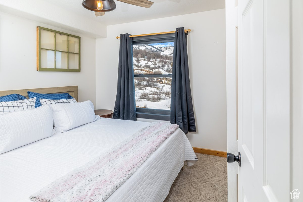 Bedroom featuring baseboards and carpet