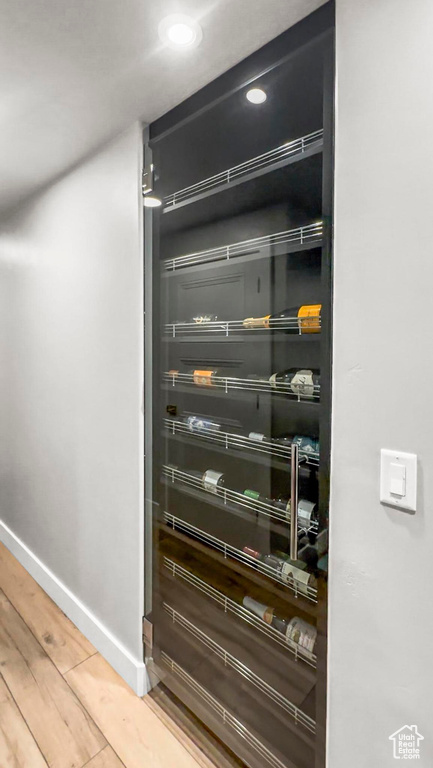 Detailed view of baseboards, wood finished floors, and recessed lighting