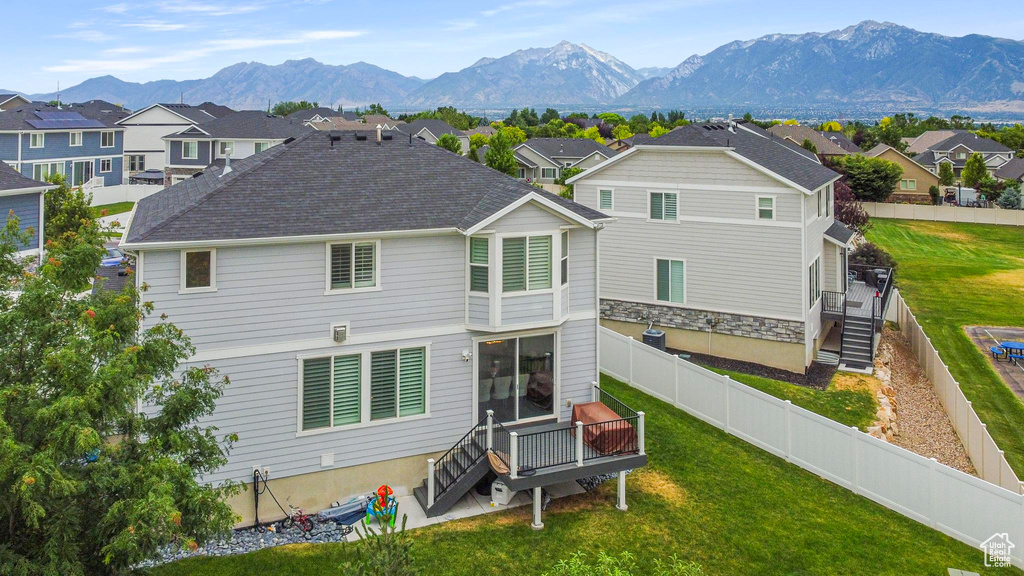 Rear view of property featuring a residential view and a deck with mountain view