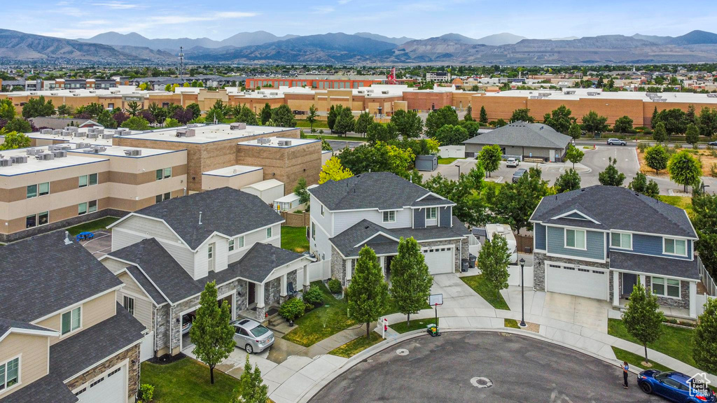 Aerial view of residential area featuring a mountainous background