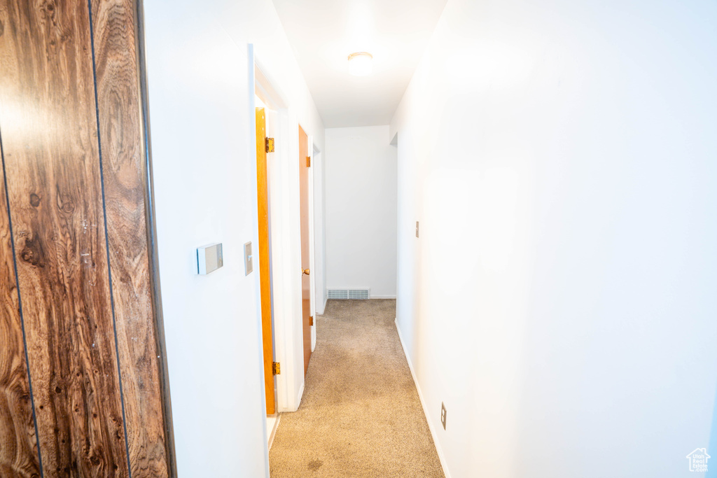 Hallway with light colored carpet