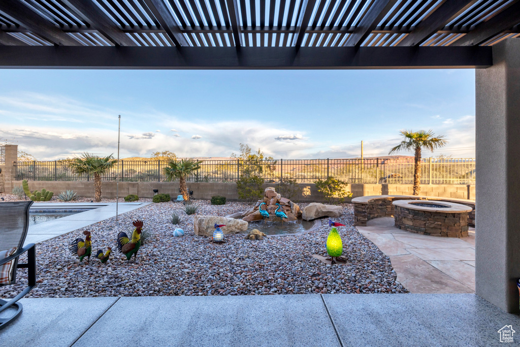 View of patio with a pergola, a fenced backyard, and an outdoor fire pit