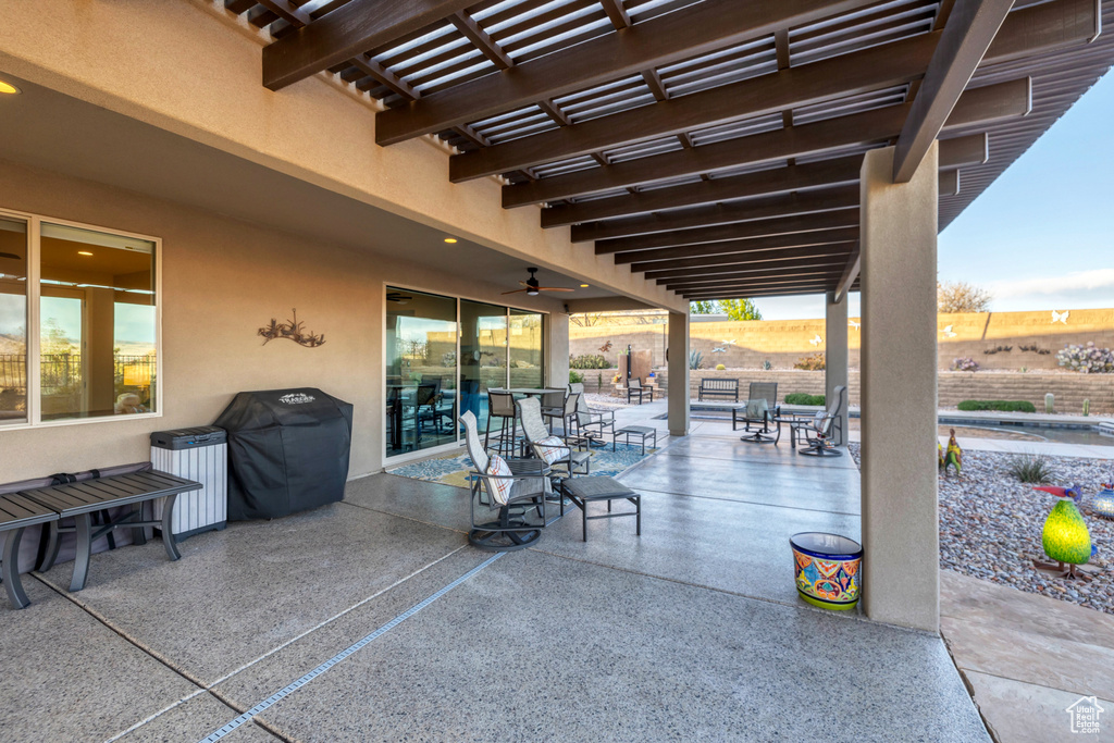 View of patio featuring a grill, outdoor dining space, a pergola, and fence