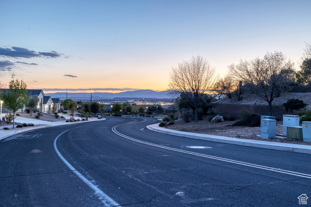 View of road featuring a mountain view and sidewalks