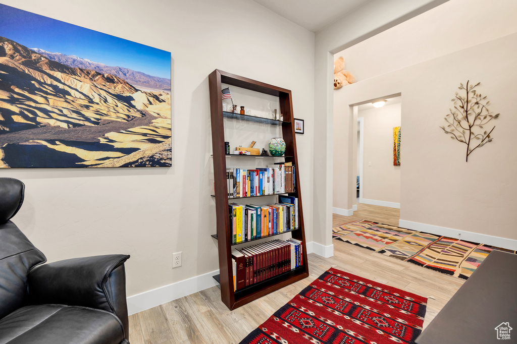 Sitting room featuring a mountain view, baseboards, and wood finished floors