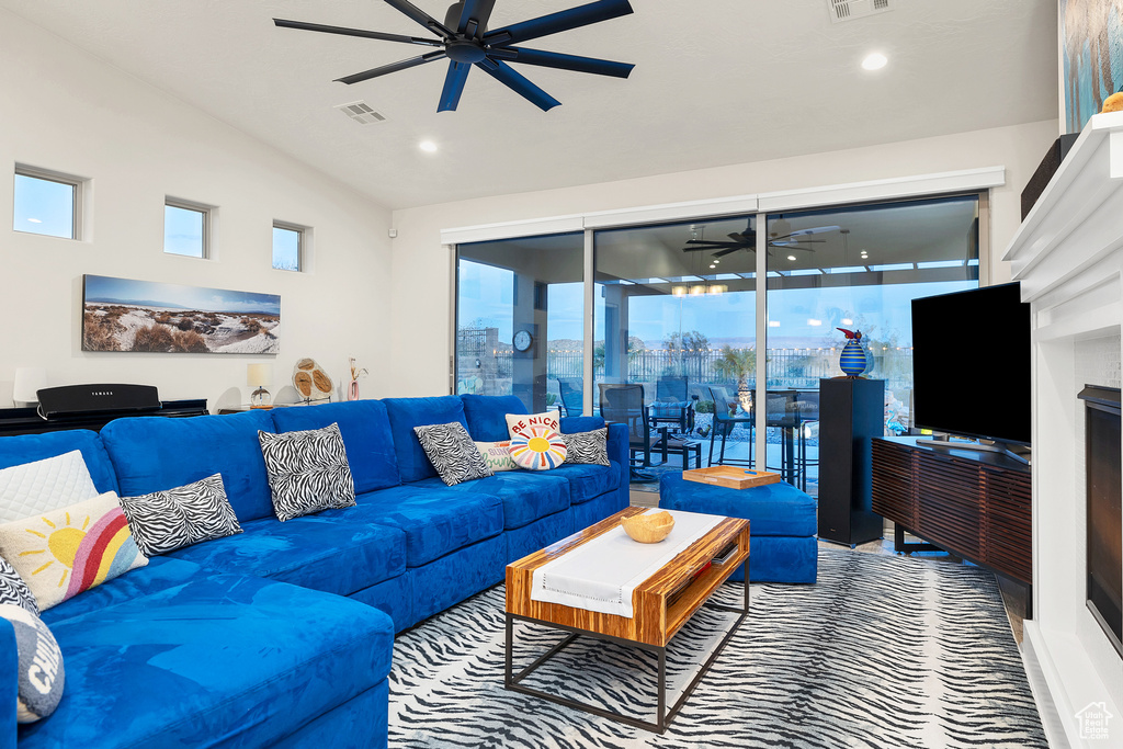 Living area featuring recessed lighting, visible vents, vaulted ceiling, and a ceiling fan