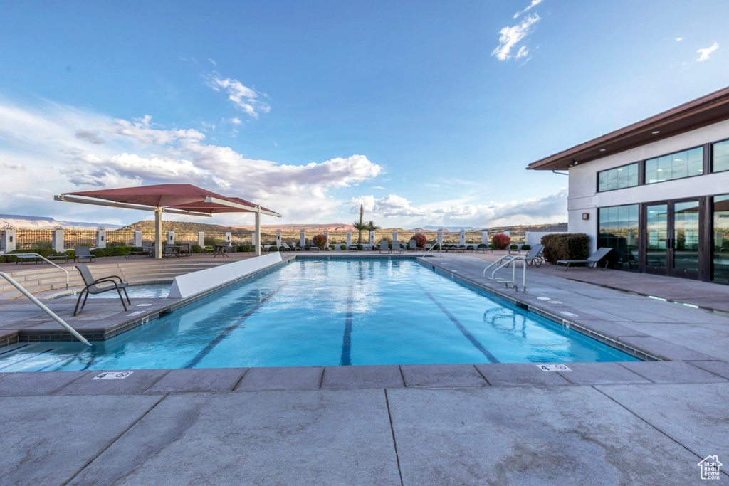 Pool featuring a patio and fence