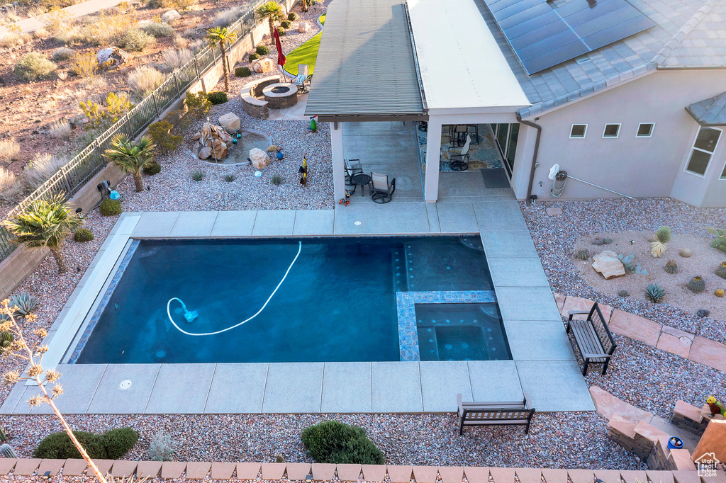 View of pool featuring a patio, an in ground hot tub, and a fenced backyard