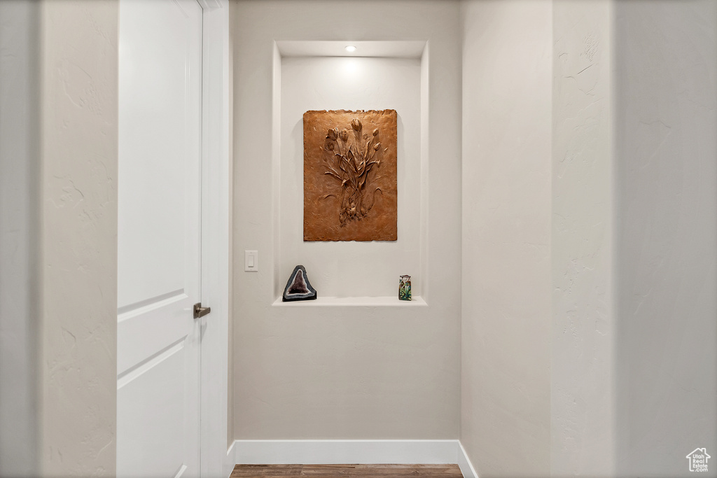 Corridor with baseboards and wood finished floors