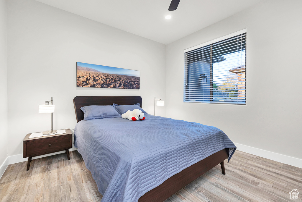 Bedroom featuring baseboards, recessed lighting, ceiling fan, and wood finished floors