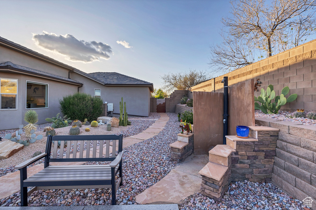 View of patio featuring fence
