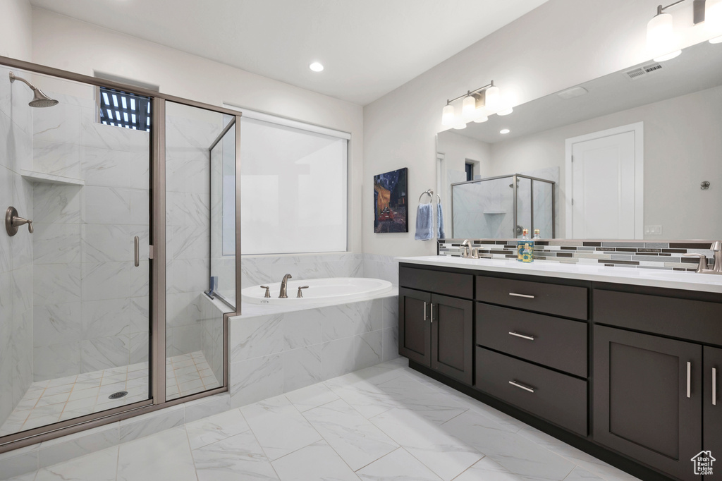 Bathroom with visible vents, a bath, double vanity, a marble finish shower, and marble finish floor
