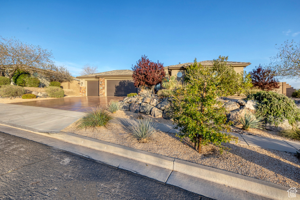 View of front of house featuring concrete driveway and a garage