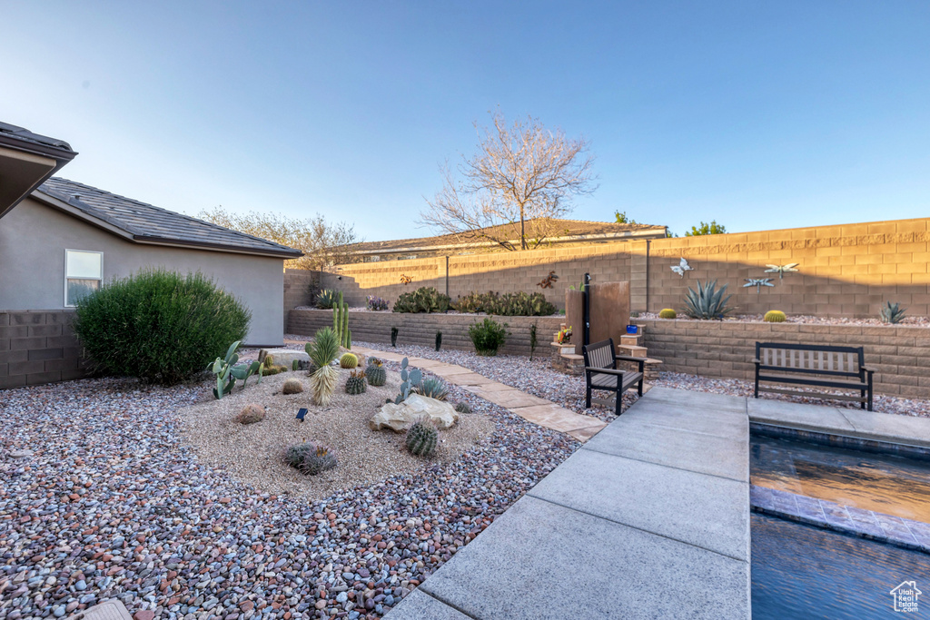 View of yard with a fenced backyard and a patio area