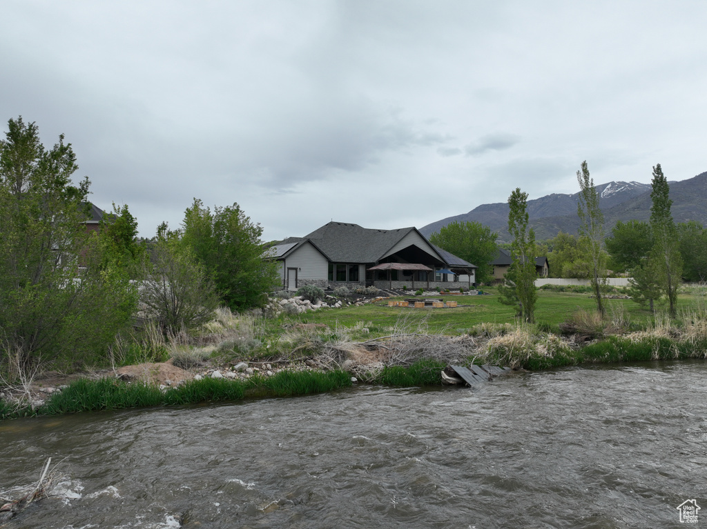 Property view of mountains with a water view