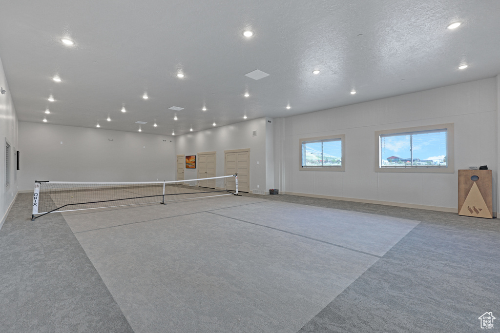 Interior space featuring light carpet, recessed lighting, and baseboards