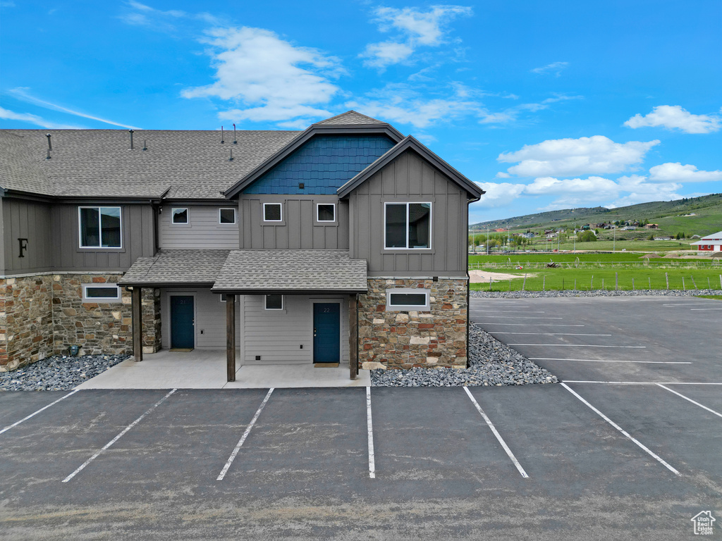 View of building exterior featuring uncovered parking and a mountain view