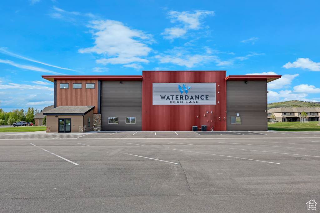 View of commercial property with uncovered parking