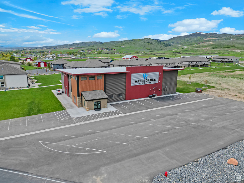 View of building exterior with a mountain view and uncovered parking