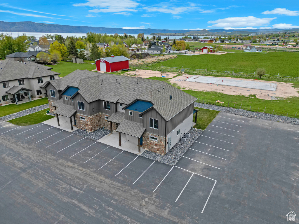 Aerial view of property and surrounding area with a mountainous background
