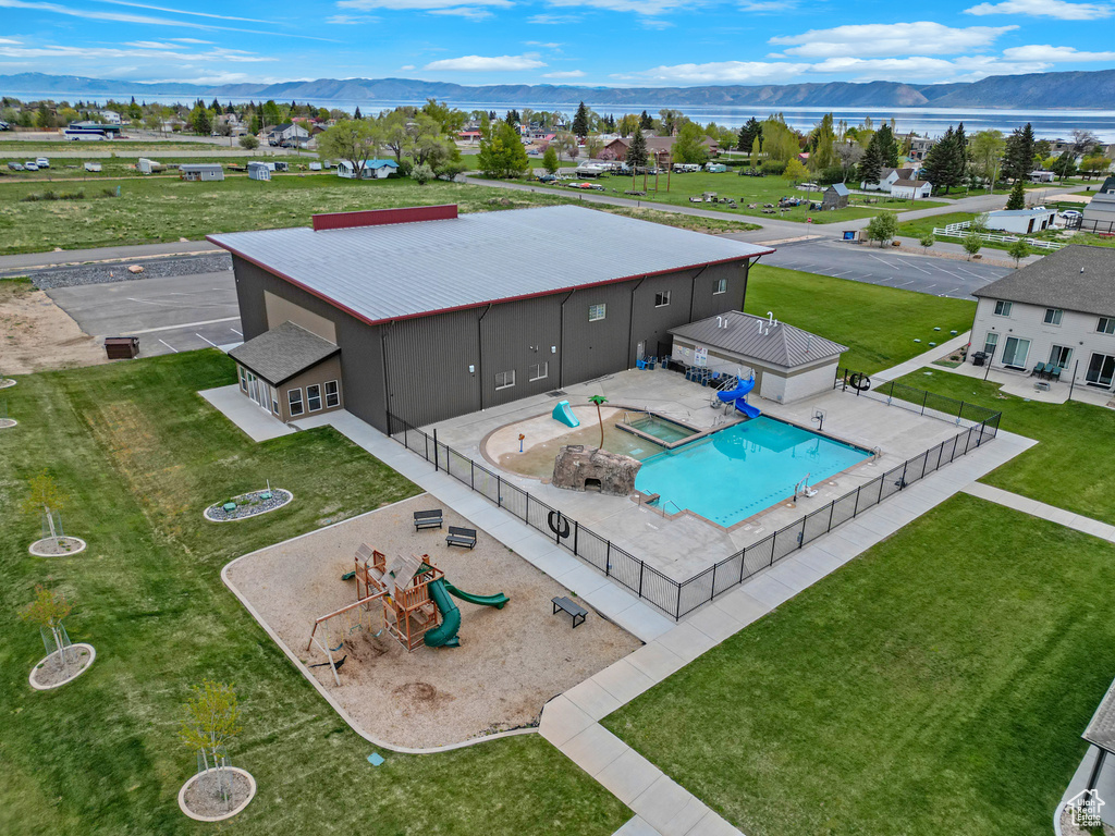 Aerial view of a pool and a water and mountain view