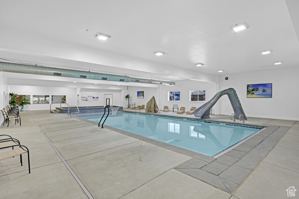 Indoor pool featuring a water slide