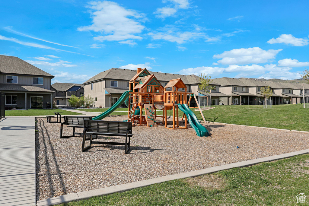 Community jungle gym with a residential view and a yard