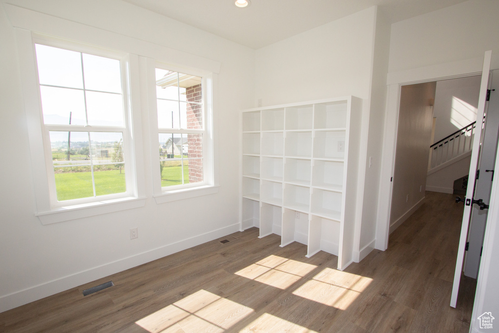 Interior space with visible vents, baseboards, wood finished floors, and stairs