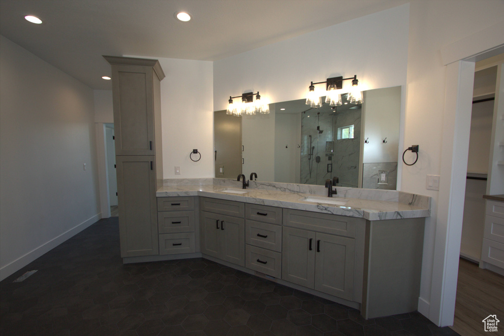 Full bathroom with a sink, recessed lighting, and a stall shower
