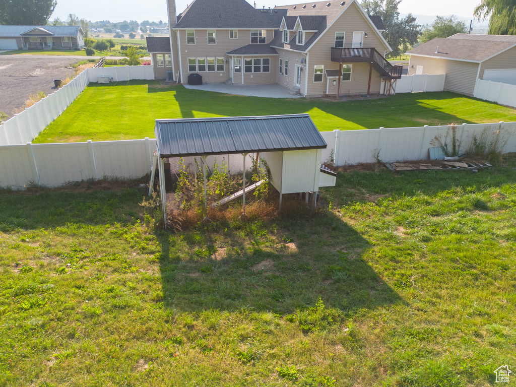 View of yard with a fenced backyard and a patio