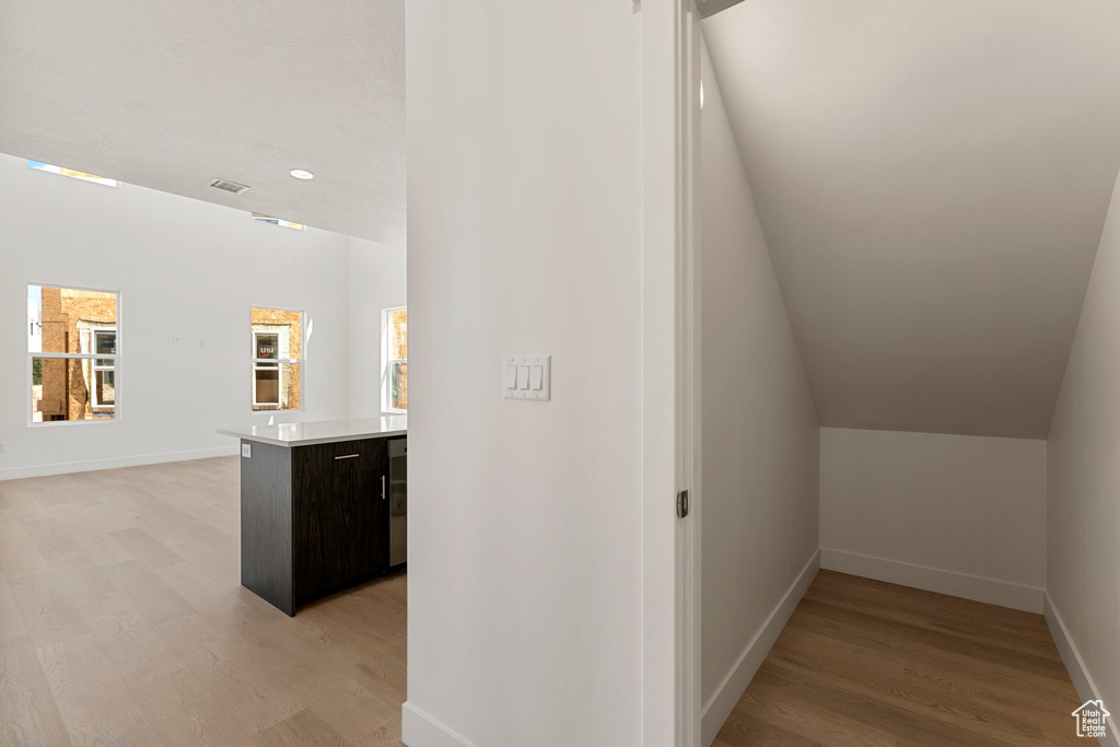 Hall featuring light wood-style flooring and recessed lighting