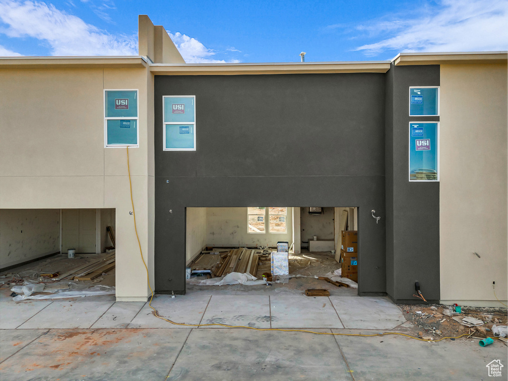 Rear view of property with stucco siding