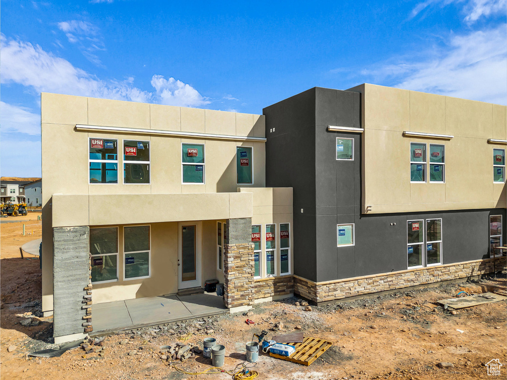 View of front of property with stone siding and stucco siding