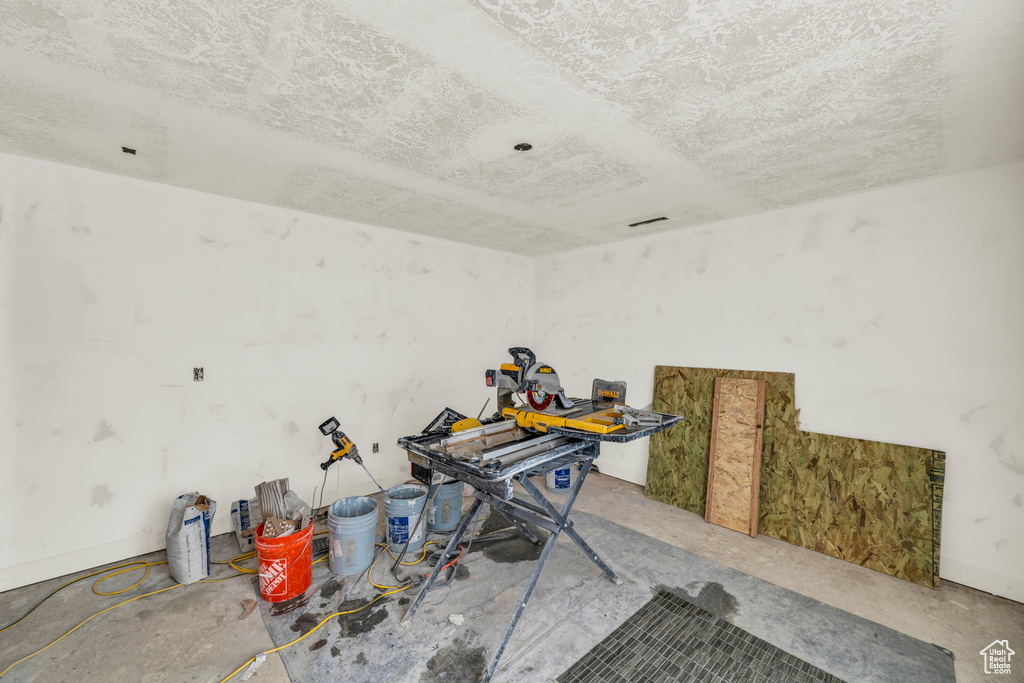 Miscellaneous room with a textured ceiling
