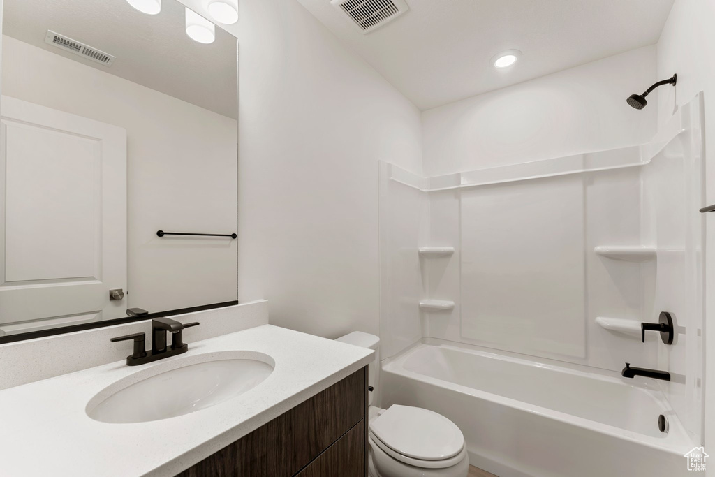 Bathroom featuring vanity, bathing tub / shower combination, and recessed lighting