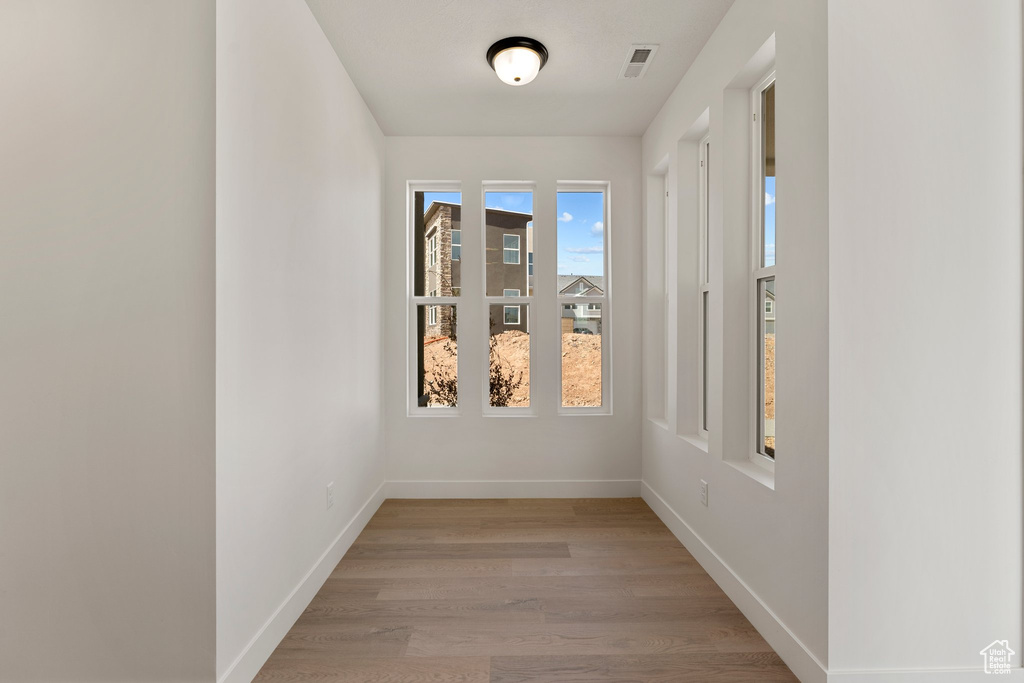 Empty room with light wood-style flooring and baseboards