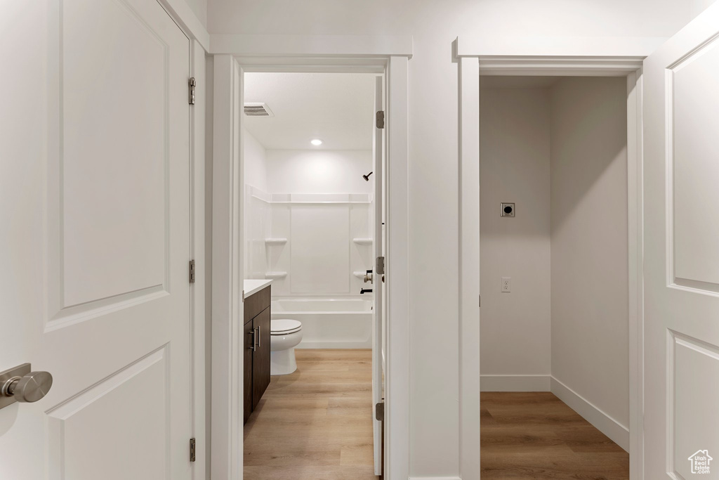 Full bathroom featuring wood finished floors, vanity, and recessed lighting