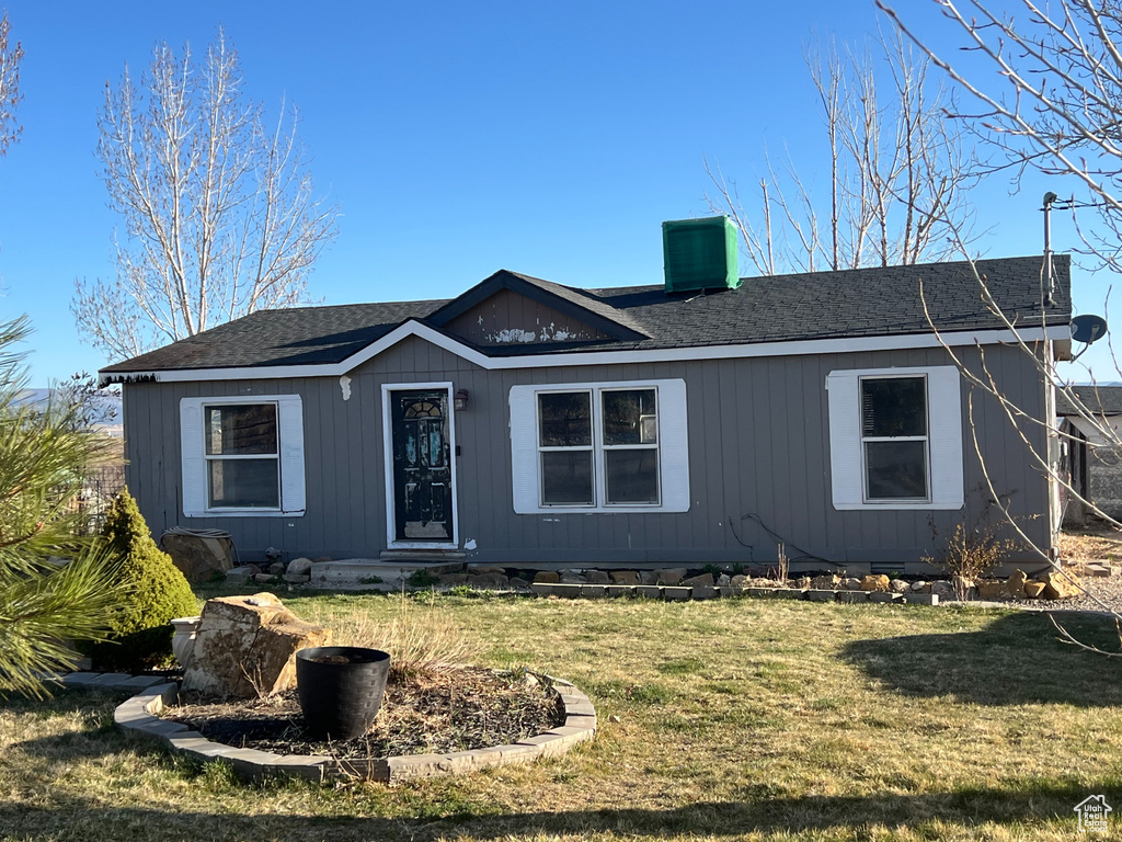 Single story home with a front yard, central AC unit, and a chimney
