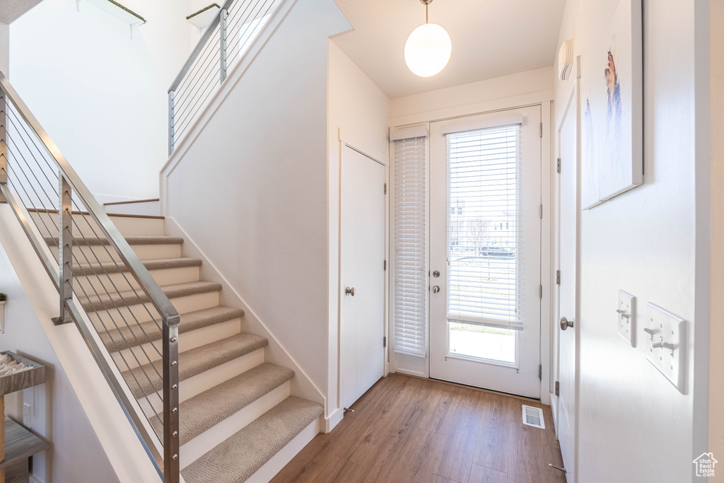 Interior space featuring stairs, visible vents, and wood finished floors