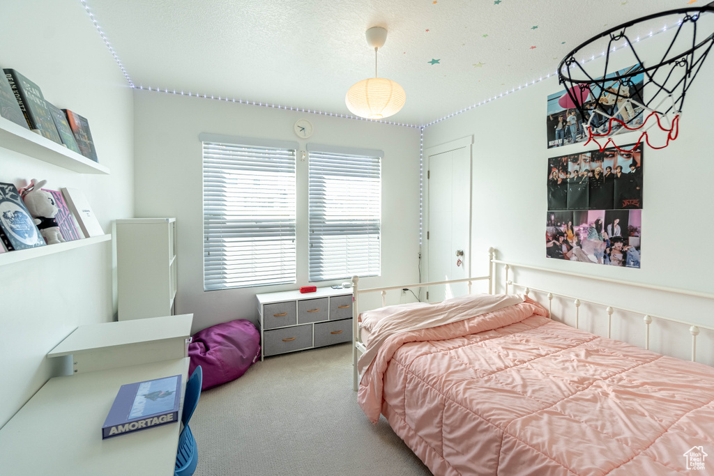 Bedroom featuring a textured ceiling and carpet
