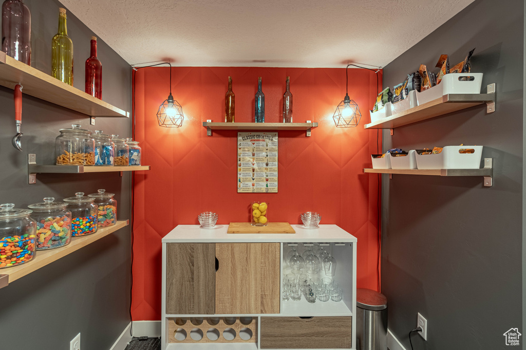 Bar with baseboards and a textured ceiling