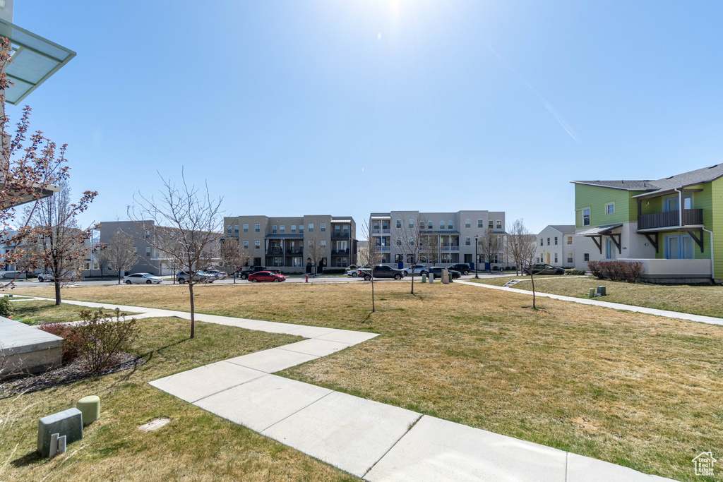 View of community featuring a residential view and a lawn