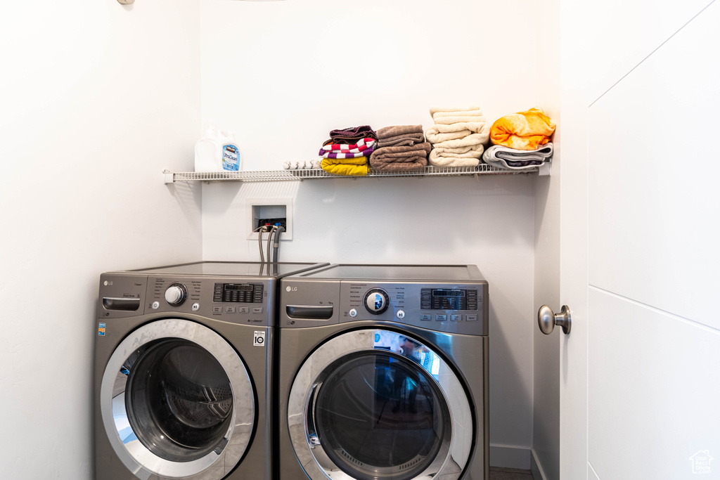 Laundry area featuring independent washer and dryer and laundry area